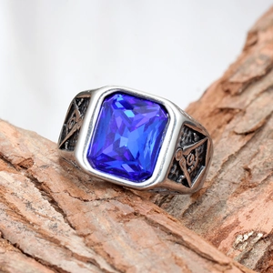 Detail of vintage men's ring with rectangle blue sapphire and Freemasonry relief symbols