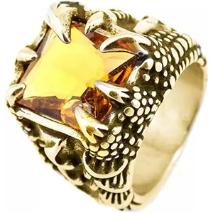Macro shot of gold dragon claw ring holding a large square yellow gemstone on white background