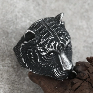 Gothic punk tiger head stainless steel ring with oxidized vintage finish on wood base