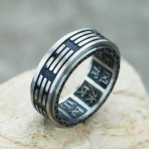Macro shot of rotatable vintage Tai Chi Bagua ring with internal Chinese character engravings