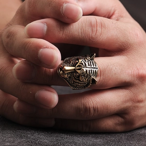 Macro shot of punk style tiger head ring with red gem eyes in vintage gold finish
