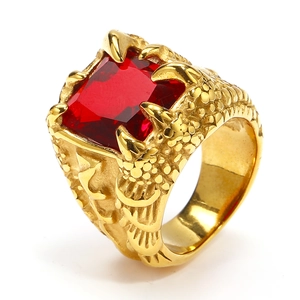 Macro detail of men's eagle claw ring with red square gemstone and dragon scale patterns