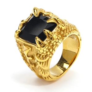 Detailed close-up of golden dragon claw ring featuring a large square black gemstone