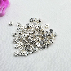 Flat round silver spacer beads made of shiny metal for DIY jewelry making and crafts