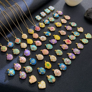Assorted vintage enamel photo locket necklaces with pearls and celestial patterns