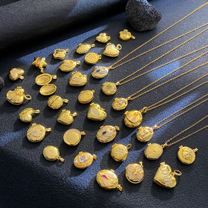 Macro shot of gold pendant necklaces with micro-set zircons and engraved LOVE text