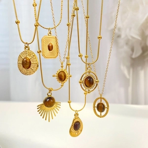 Vintage style gold tiered necklaces with brown tiger eye stone pendants on fine gold chains