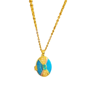 Golden locket necklace with blue enamel and crystal inlay on a delicate link chain