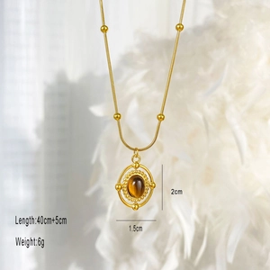 Vintage style gold necklace featuring a round brown tiger eye stone pendant and beads