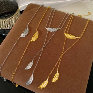 Fashionable layered necklace and bracelet set with sparkly leaf feather pendants