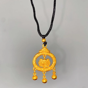 Detail of traditional Chinese gold pendant with bells and ruyi pattern on black cord