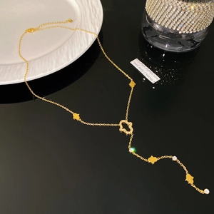Detailed view of a gold Y-shaped necklace featuring sparkling Hamsa Hand charms and zircons
