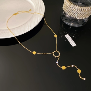 Detail of 18K gold-plated Y-necklace with tassels and sparkling cubic zirconia stones
