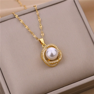 Detailed shot of a 18k gold plated geometric pendant with pearl and shimmering pavé diamonds