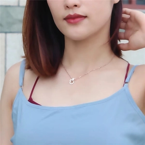 Minimalist rose gold heart-shaped double outline pendant necklace on a model