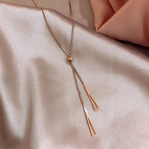 Detail of rose gold box chain with adjustable sliding bead and geometric triangle pendants