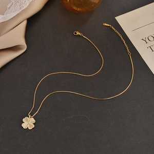 Macro detail of gold clover necklace with cat eye petals and lobster clasp closure