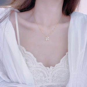 Exquisite gold-plated clover necklace with white petal inlay on a model's neck