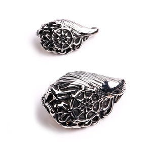 Detailed view of retro silver titanium steel pendants with wings and intricate gear engravings