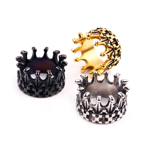 Macro shot of crown rings in black, gold, and silver with checkerboard patterns