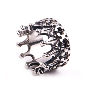 Macro shot of crown ring detail featuring vintage cross relief and gothic punk texture