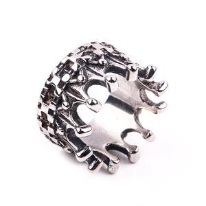 Macro detail of gothic crown ring featuring vintage embossed textures and steel finish