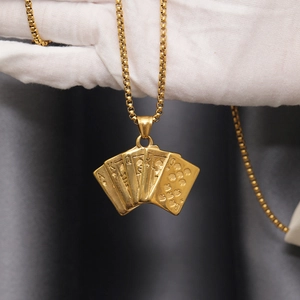Close-up of golden poker cards pendant featuring A K Q J fan design on a box chain