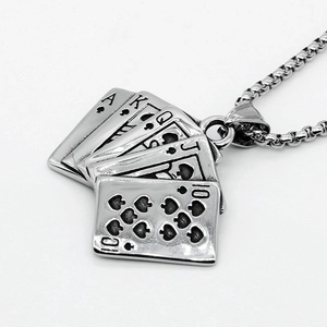 Macro shot of vintage titanium steel royal flush playing card pendant with black details