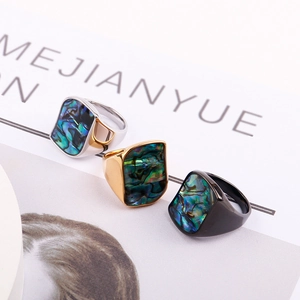 Three geometric titanium steel rings with colorful abalone shell inlays in silver, gold, black