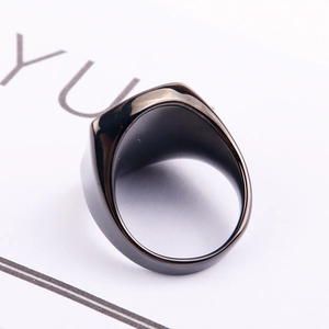 Detailed macro view showing the thick inner band and polished black finish of the titanium ring