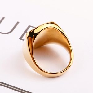 Macro view of polished gold signet ring showcasing smooth inner band and solid craftsmanship