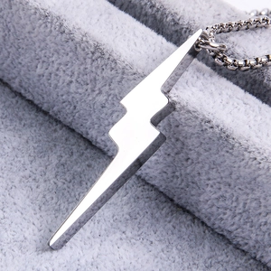 Macro detail of a high-polished lightning bolt pendant with a sturdy steel box chain