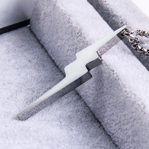 Polished lightning bolt pendant on a silver box chain with close-up metallic details