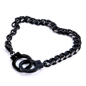 Detail of heart-shaped black metal handcuff jewelry with engraved UNLOCK text