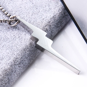 Macro shot of polished silver lightning bolt pendant in durable titanium steel