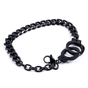 Detail of black Cuban link bracelet featuring a polished handcuff charm with Unlock text