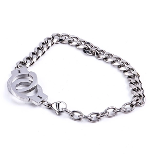 Detail of stainless steel handcuff link bracelet with freedom and lock engravings