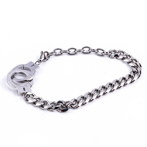 Detail of silver stainless steel handcuff bracelet with UNLOCK and PUT DOWN engravings
