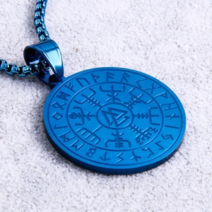 Macro shot of blue Viking Valknut pendant with Rune circle and bead chain necklace