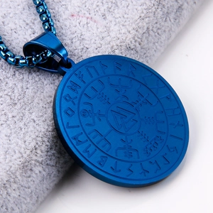 Macro shot of blue stainless steel Viking Vegvisir compass pendant with Nordic runes