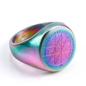 Detail of rainbow titanium steel signet ring with engraved hexagram and mystic symbols