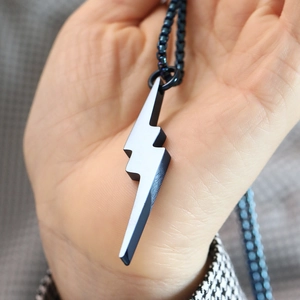 Macro shot of hip hop style lightning bolt pendant in gunmetal grey finish