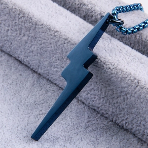Close-up of blue lightning bolt pendant with matte finish and matching box chain necklace