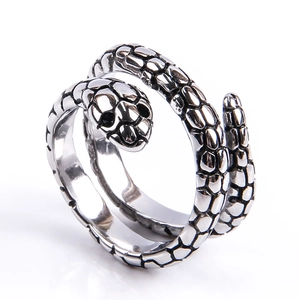 Detailed close-up of a silver snake wrap ring with scale texture and black stone eyes