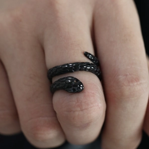 Detail of black snake-shaped ring showing intricate scales and gothic punk design