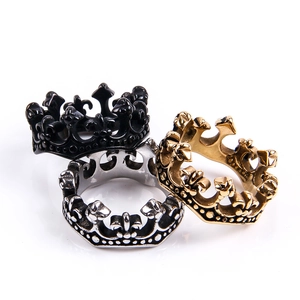 Detailed macro view of three-piece crown rings in black, gold, and silver finishes