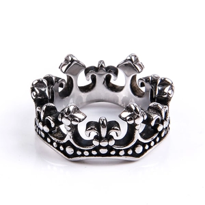 Detailed macro view of retro stainless steel crown ring with gothic fleur-de-lis patterns