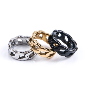Detail of interlocking Cuban link rings in polished silver, gold, and black finishes