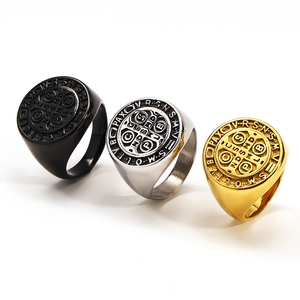 Three-color St. Benedict Medal rings in black, gold, and silver stainless steel finishes