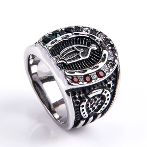 Macro shot of retro men's ring featuring Virgin Mary emblem and horseshoe with crystals